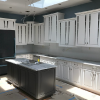 Custom CNC cut panels with glass see-through in the upper cabinets.